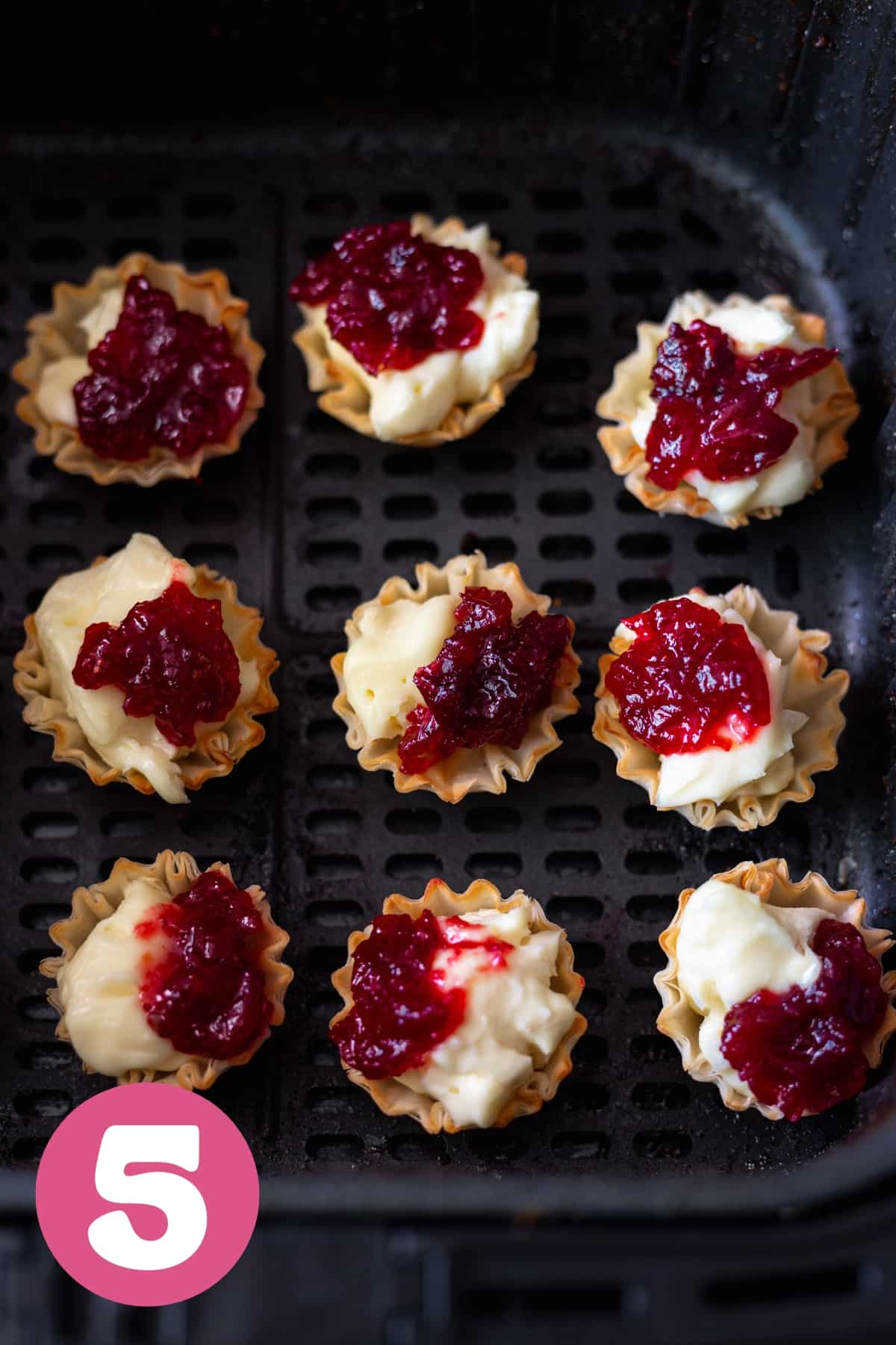 Phyllo brie cranberry cups inside a black air fryer labeled step 5