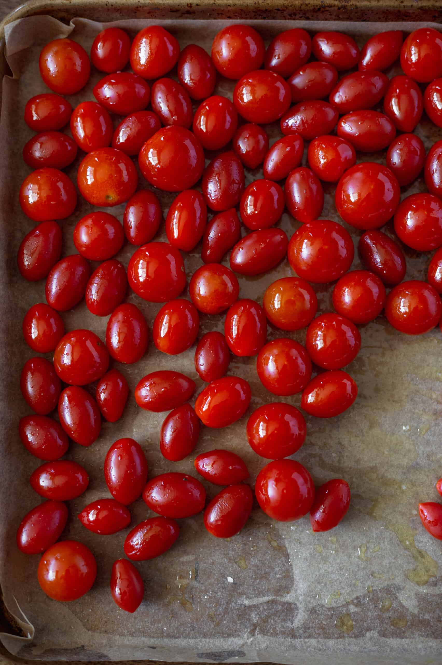 Whole cherry tomatoes on a sheet pan