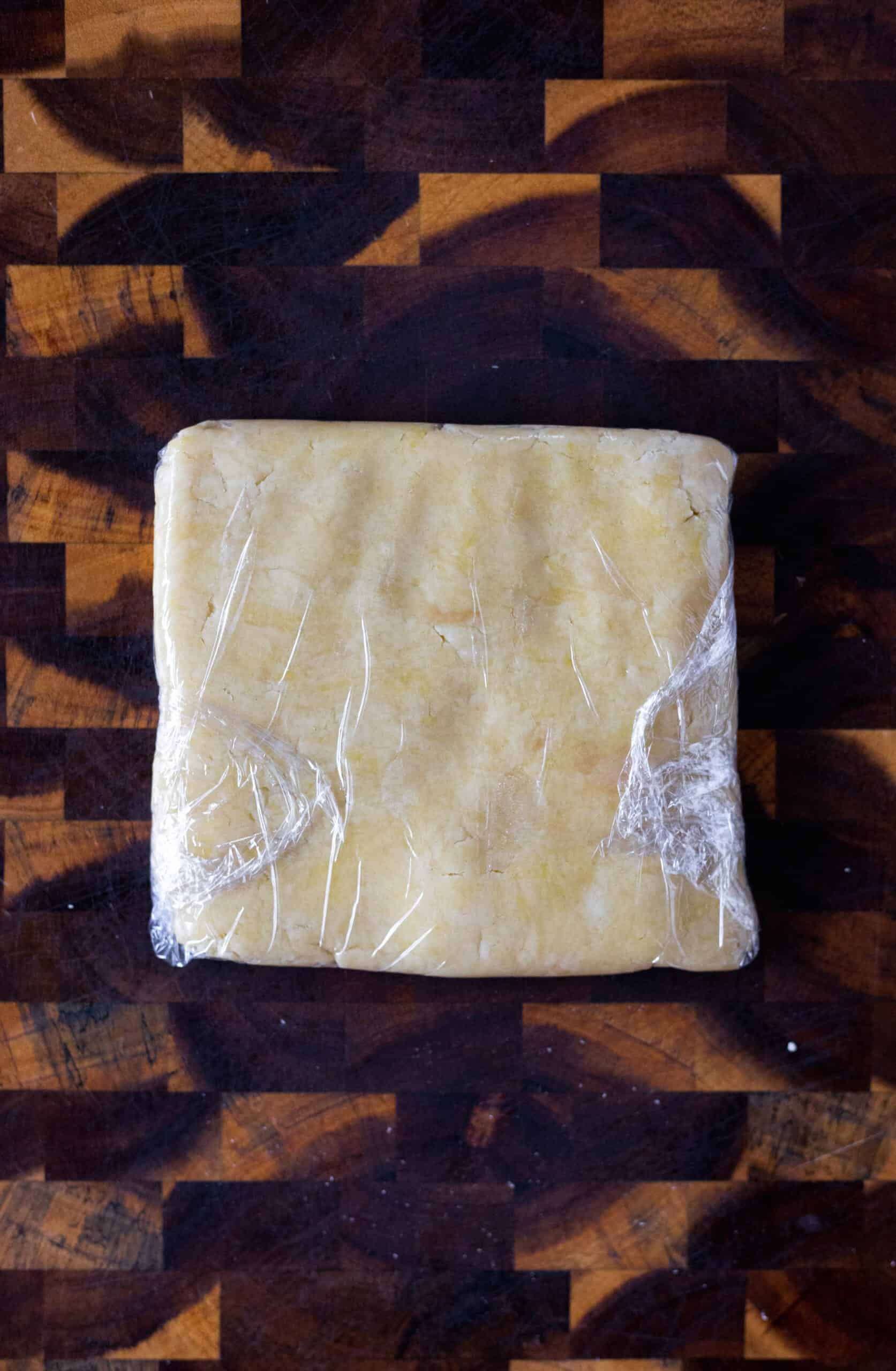 Shortbread crust dough wrapped in plastic wrap
