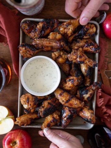 People grabbing chicken wings at a party
