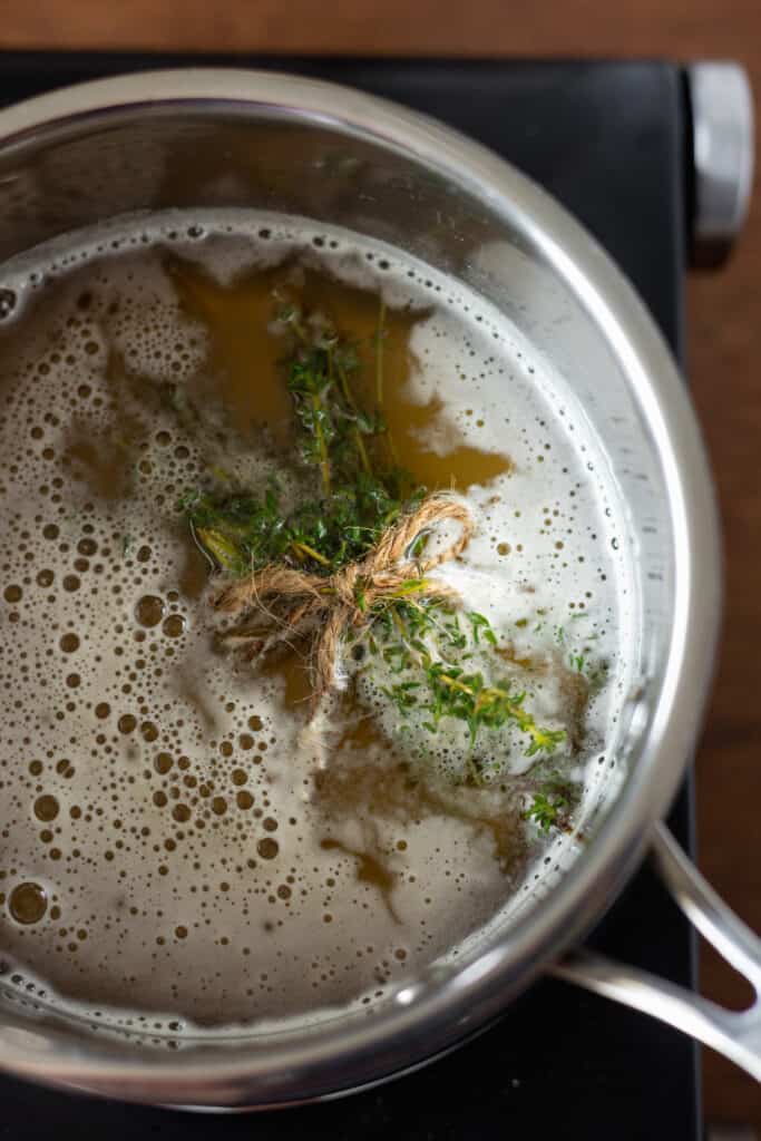 Tied thyme with honey in a saucepan
