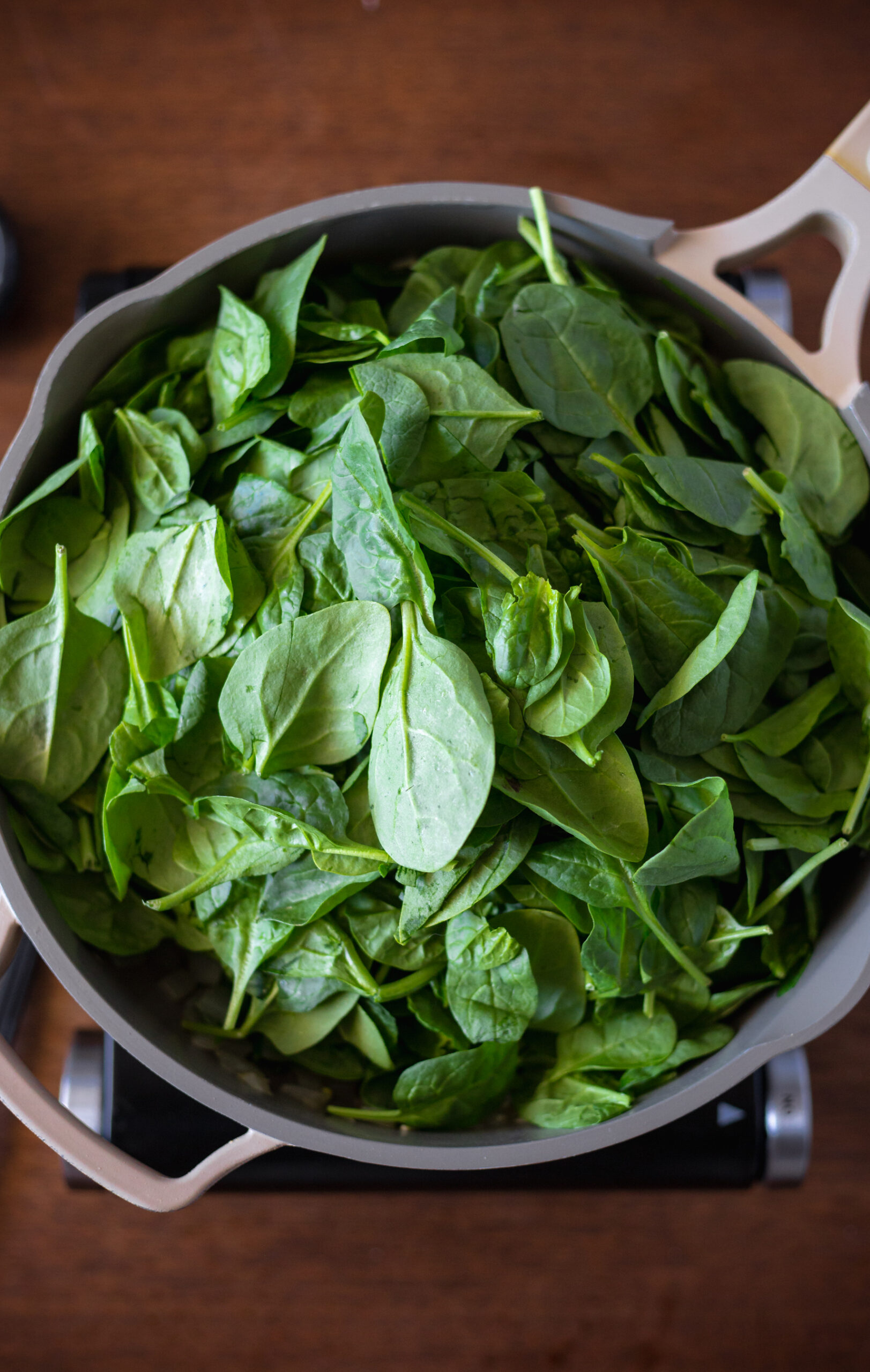 fresh spinach in large saucepan