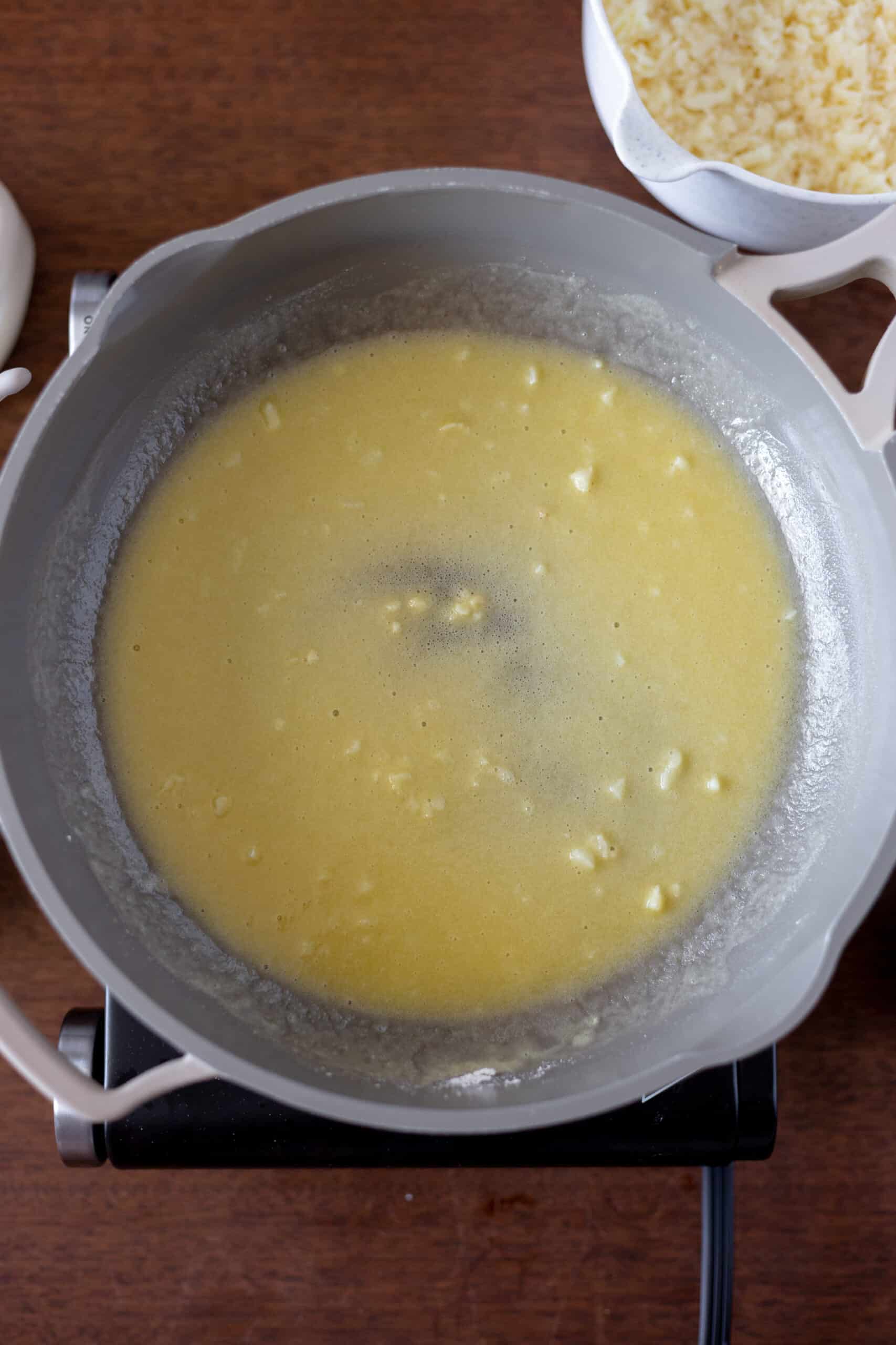 Heavy cream added in roux in large pan