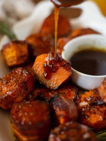 Fondant Sweet Potatoes being drizzled in rosemary sauce