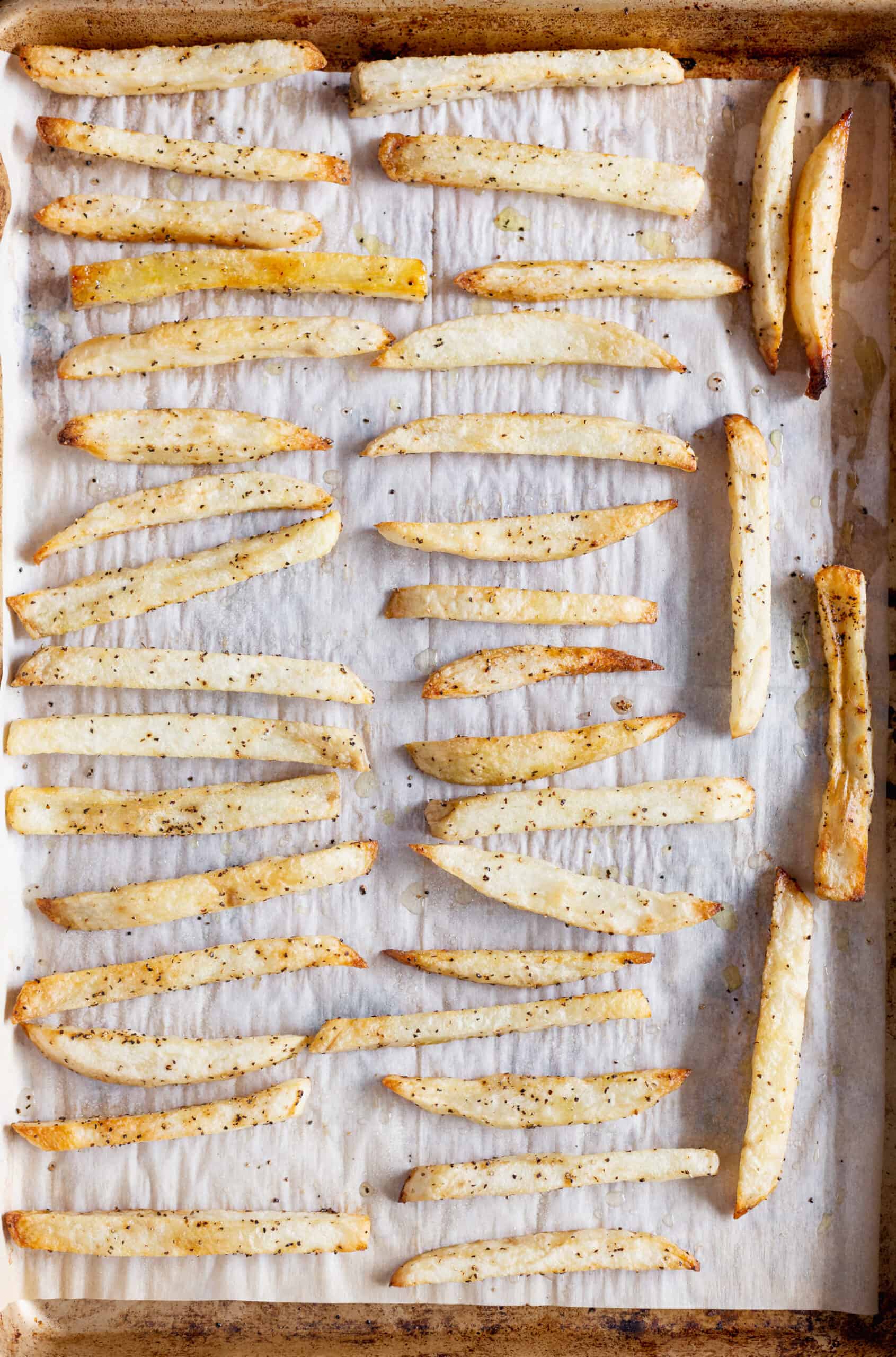 baked cut fries on a sheet pan