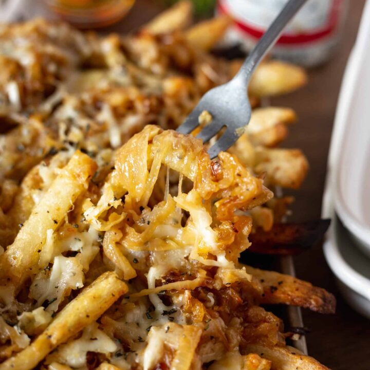 french onion fries being stabbed with fork