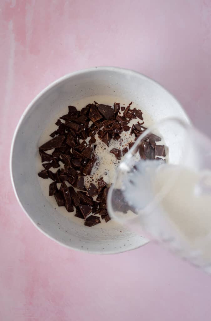 Almond milk being added to chocolate ganache