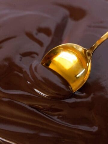 golden spoon being dipped into chocolate