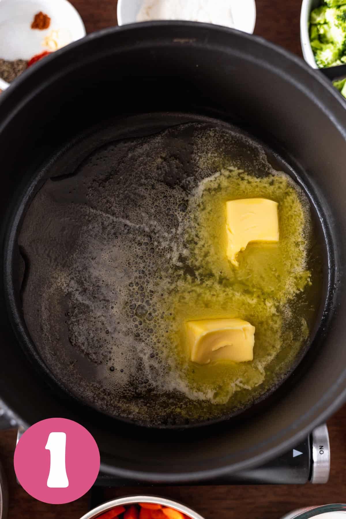 Melted butter in a large black dutch oven