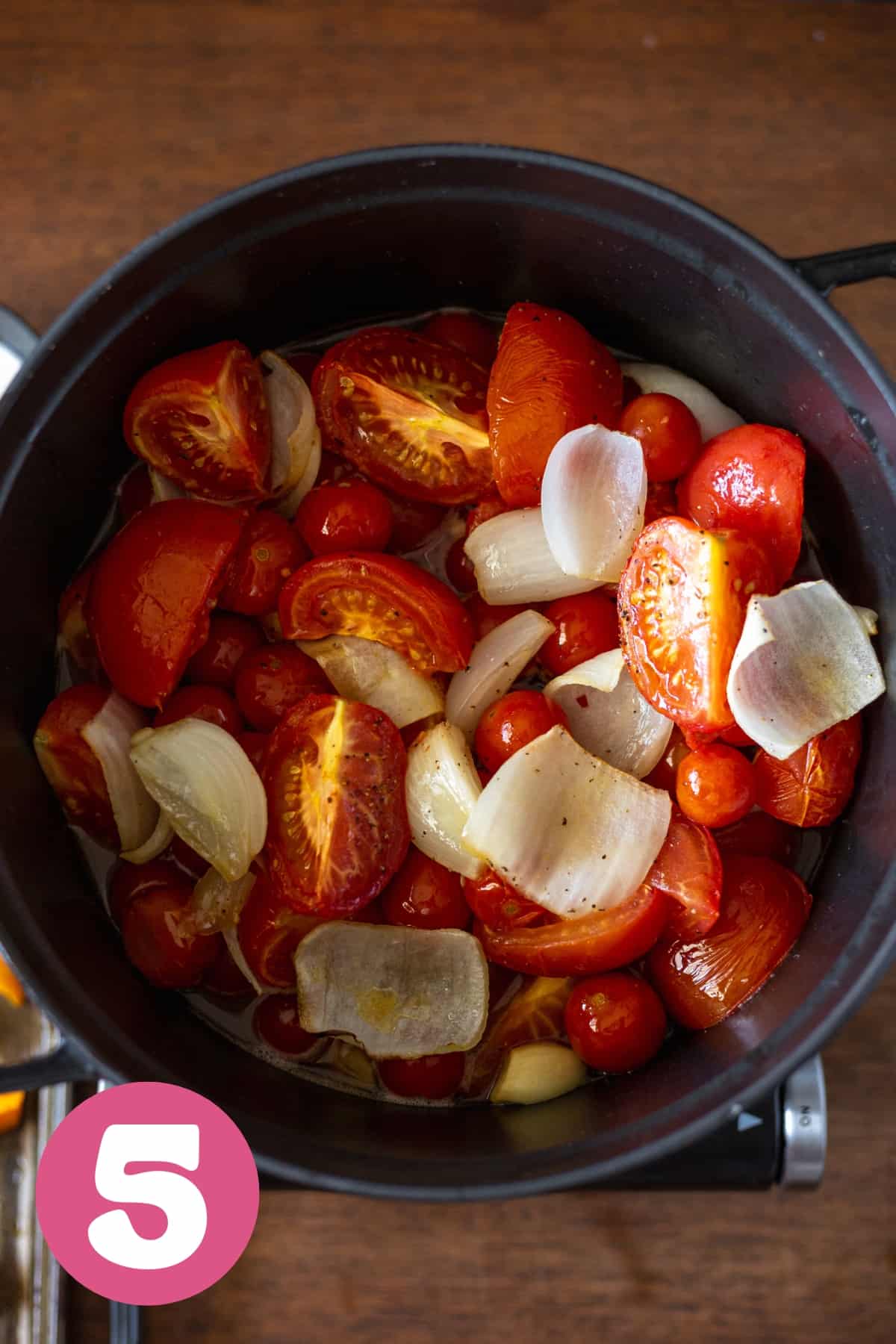Roasted tomatoes onions and garlic in a dutch oven