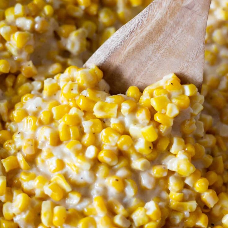 Close up of the creamiest creamed corn on a spoon