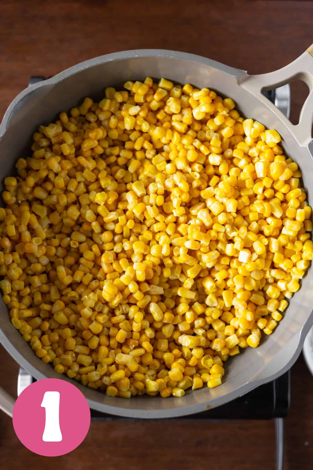 Frozen corn kernels in a large saucepan labeled step 1