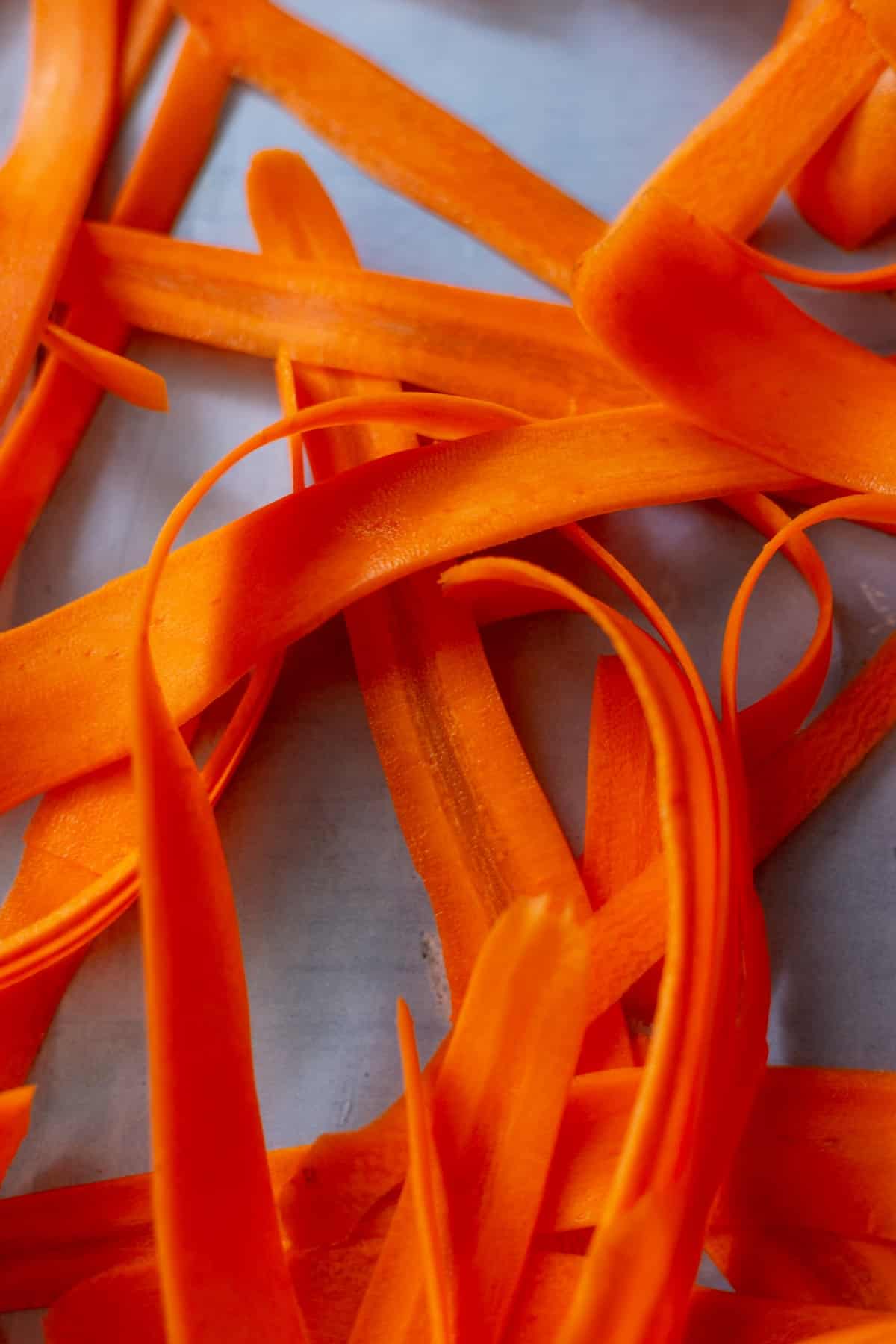 Slices of carrots or carrot ribbons in a pile