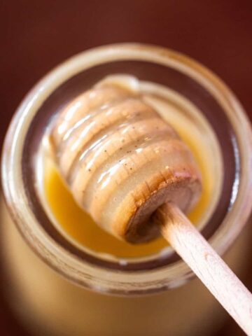 Honey that has been whipped on a honey spoon over a jar