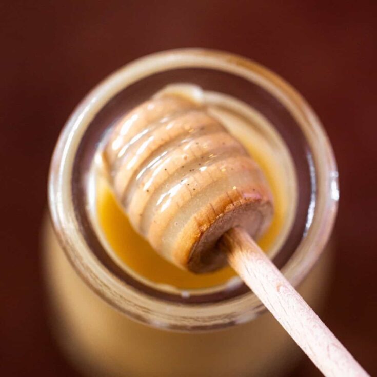 Honey that has been whipped on a honey spoon over a jar
